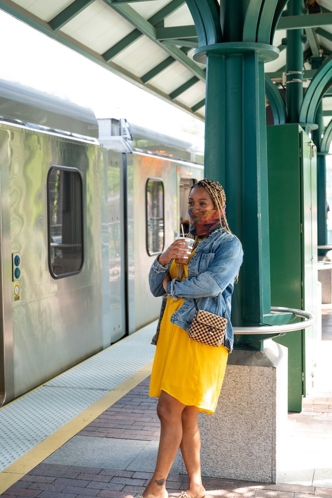 Woman standing outside on train platform waiting for her train