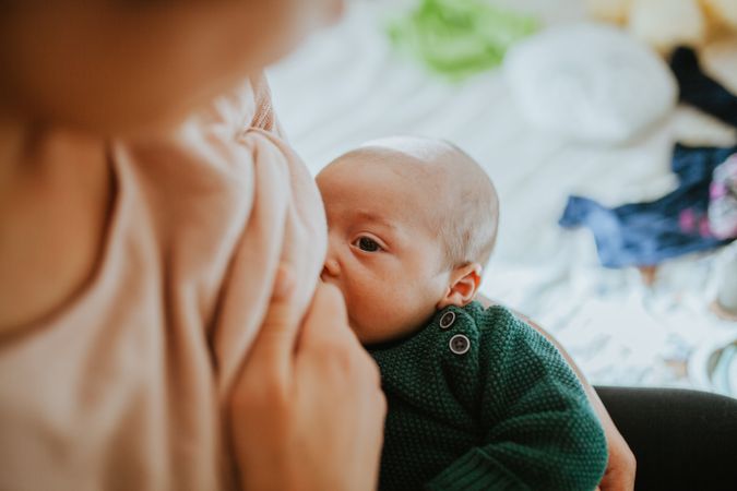 Newborn being breast-fed at home