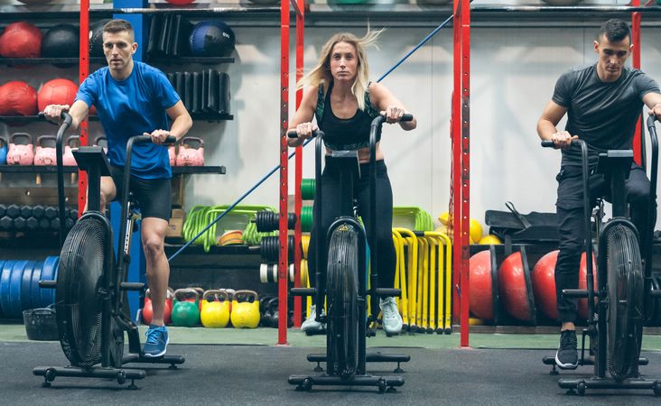 Athletes doing air bike indoor