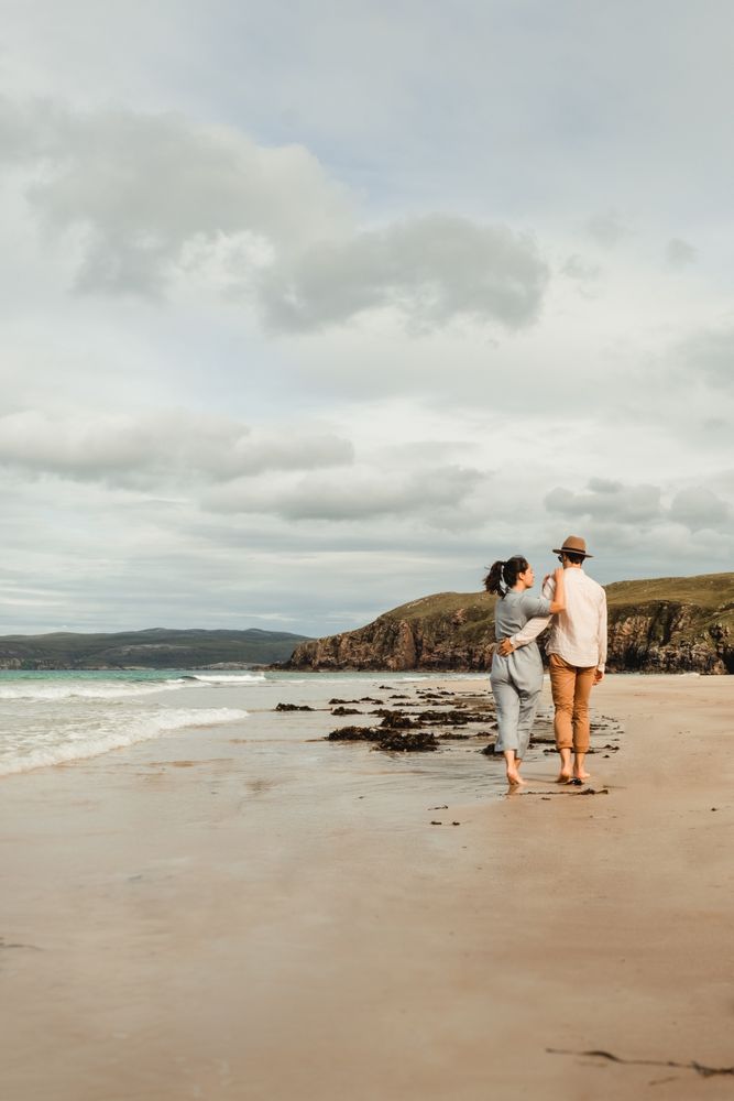 Happy couple having fun on Scottish coast