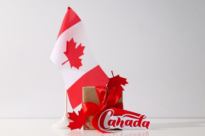 Canadian flag with a gift on a light background