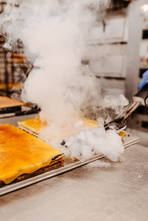 Anonymous confectioner burning cake on table