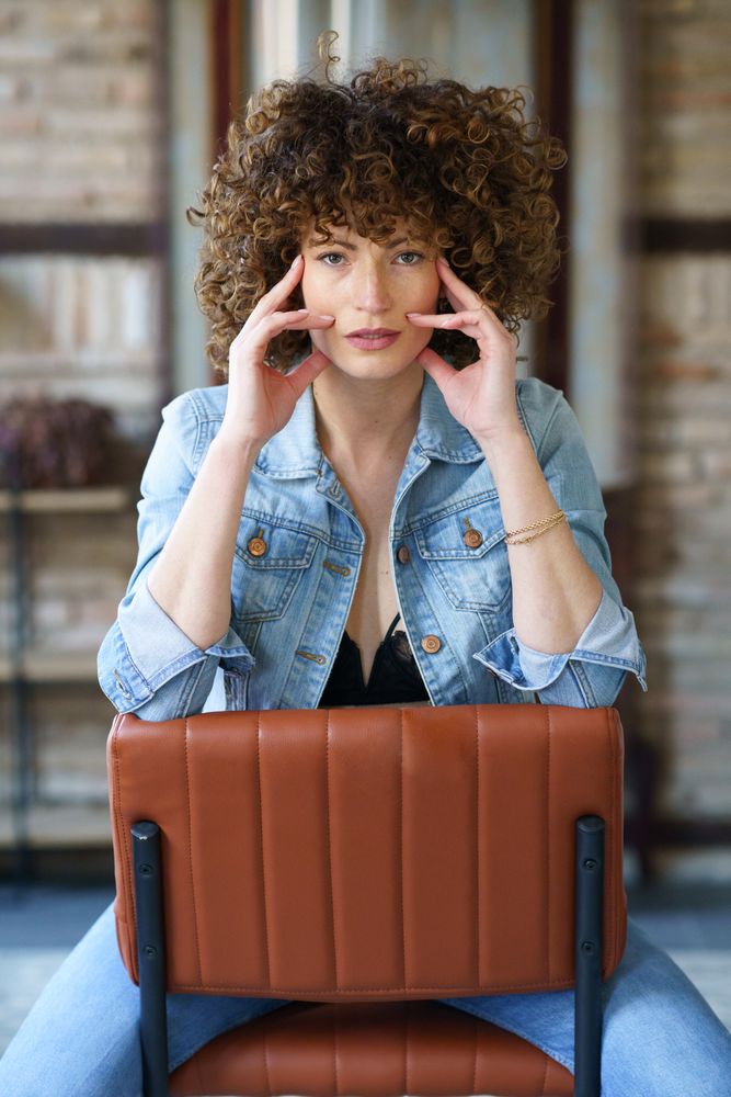 Woman sitting on backward chair