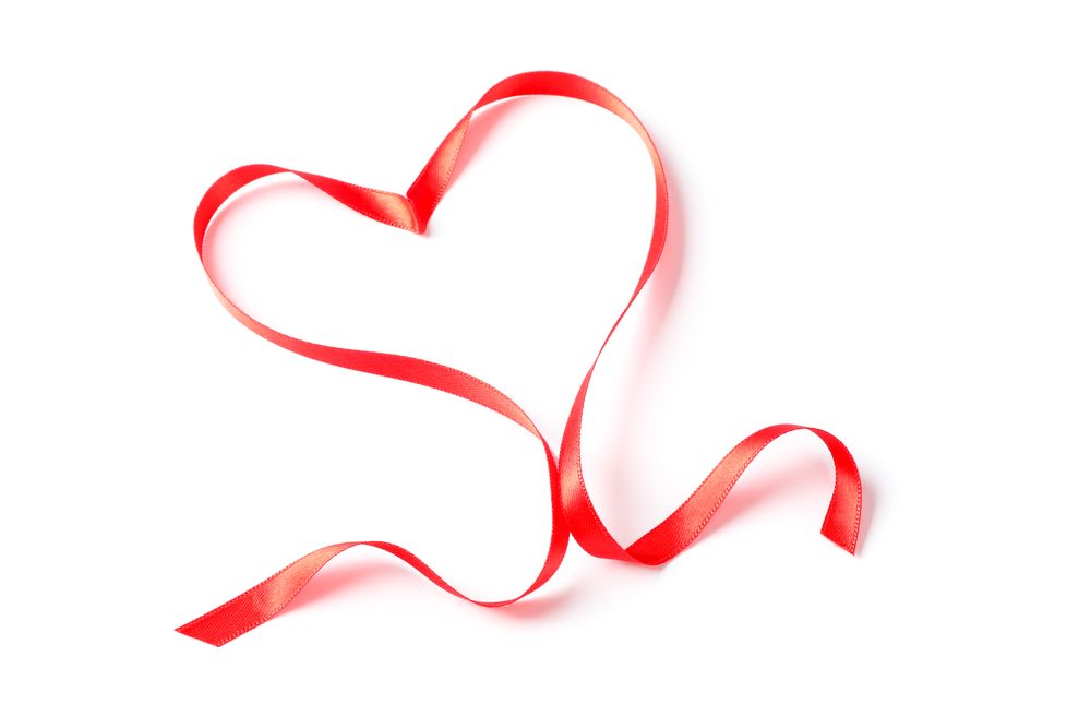 Red ribbon heart isolated on blank background