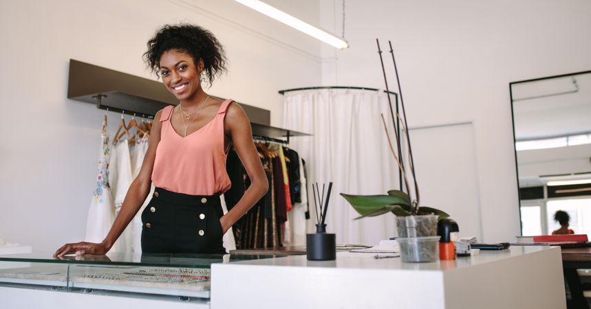 Black fashion store owner standing at her desk