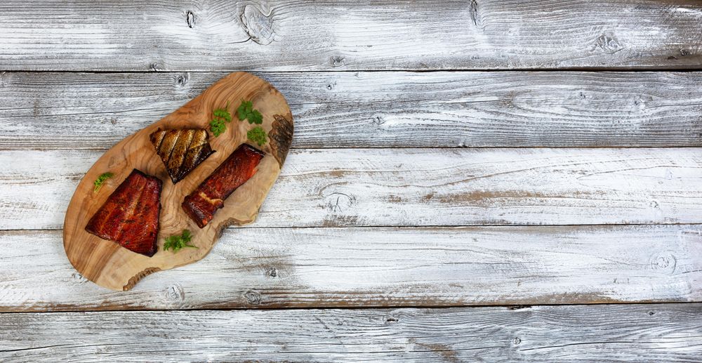 Smoked salmon trout on olive board