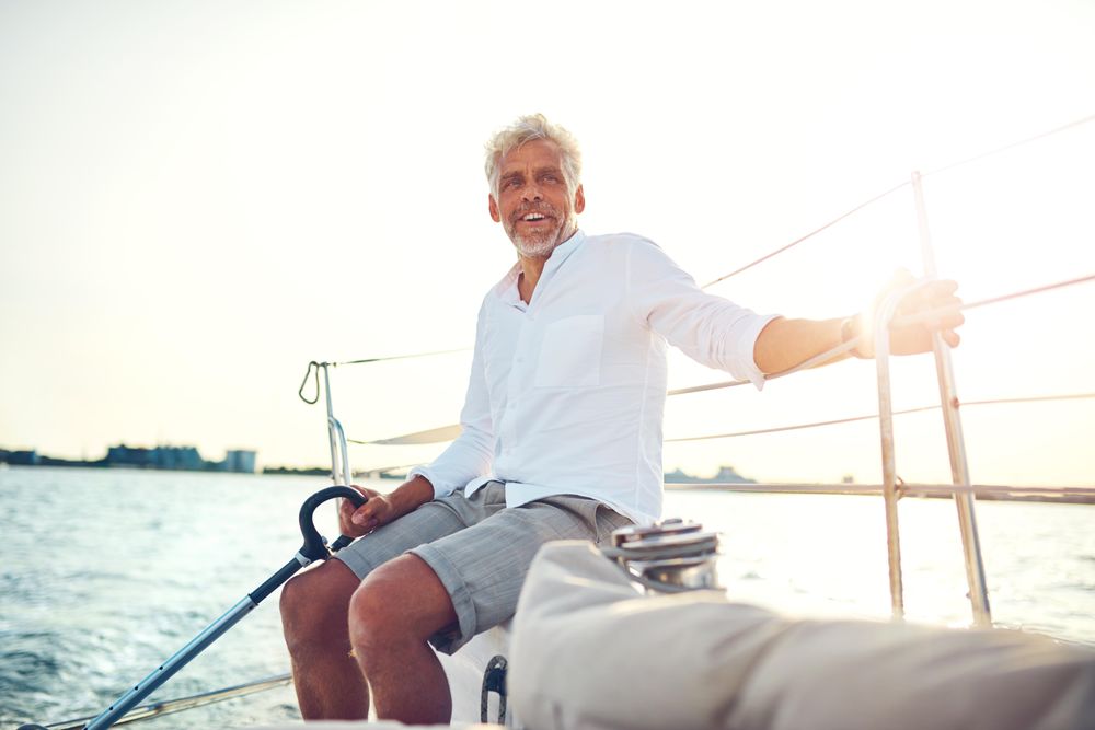 Man sitting and relaxing on sailing yacht on sunny day