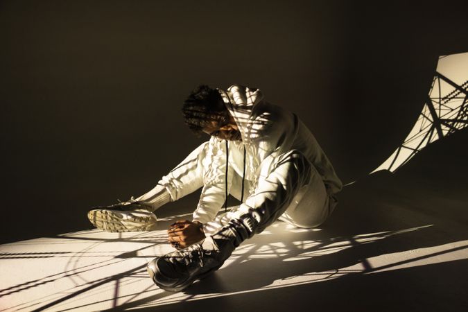 Black man dancing under bright light