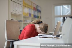 Tired woman sleeping on laptop keyboard 0LJXP4