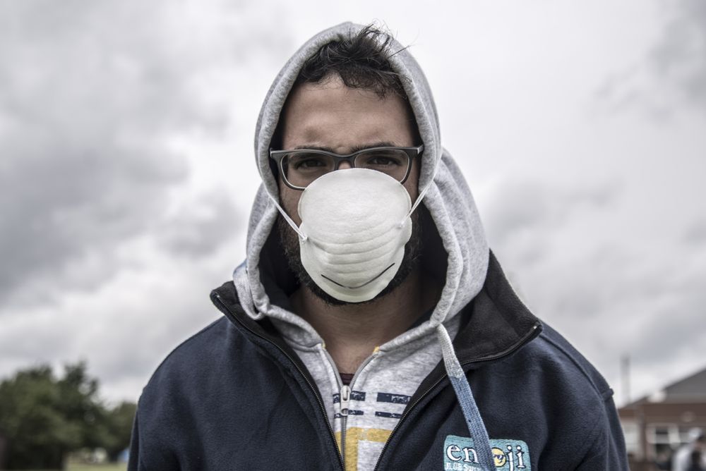 Man in hoodie wearing  facemask