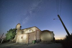 Aged cathedral in suburbs under starry sky