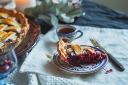 Sweet fruit filled berry pie plated with fork