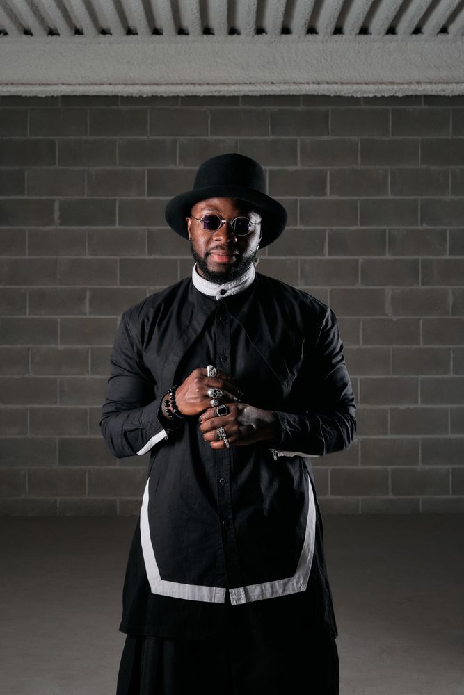 Black man standing in dark room