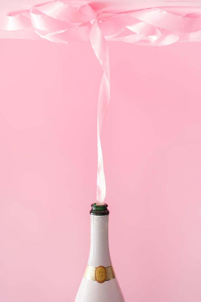 Champagne bottle with pink party ribbon