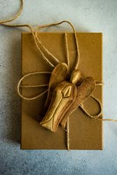Holiday card concept with angel ornament on gift box