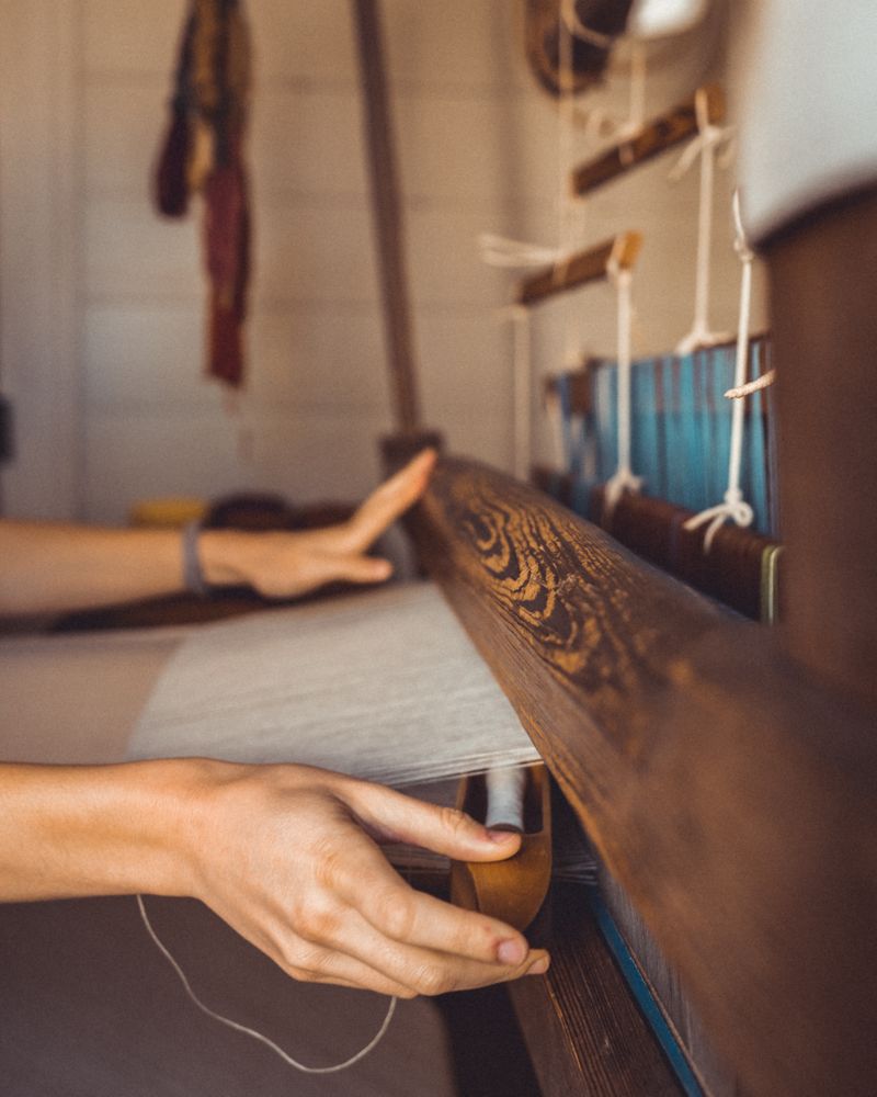 Woman using knitting machine