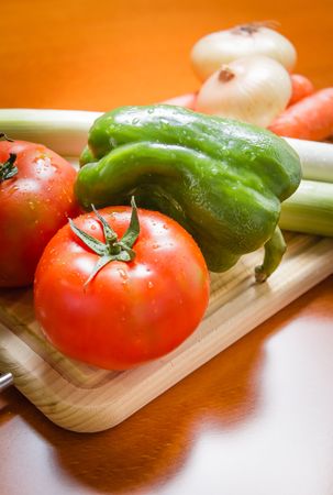 Fresh vegetables on cutting board in the kitchen
