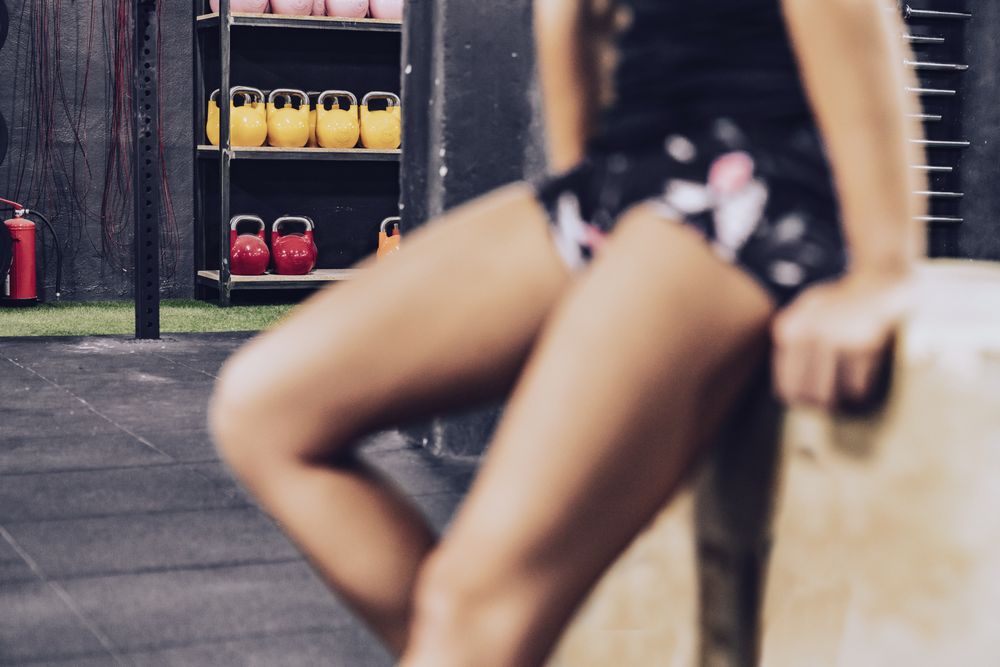 Slender woman having break in fitness club
