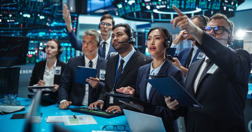 Diverse Stock Exchange Professionals Communicating in an Open Outcry Method on a Trading Floor.