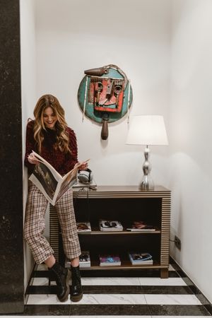 Stylish woman reading magazine