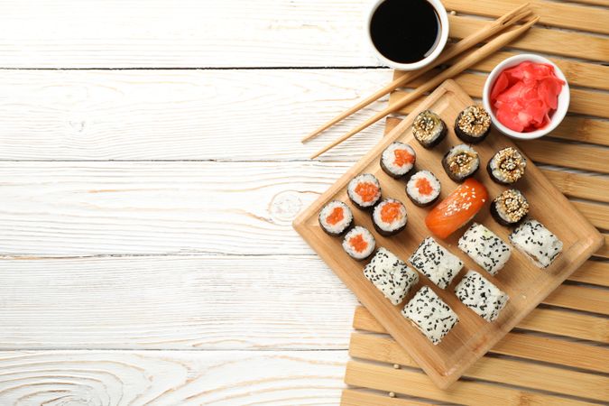 Composition with sushi rolls on wooden background, top view. Japanese food