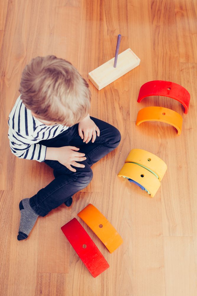 Boy playing with wooden construction pieces