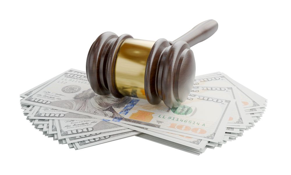 Gavel Resting on Stacks of Thousands of Dollars Isolated