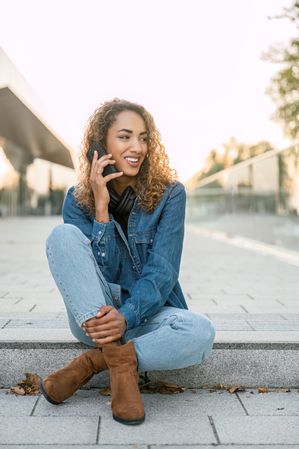 Smiling woman talking on smartphone
