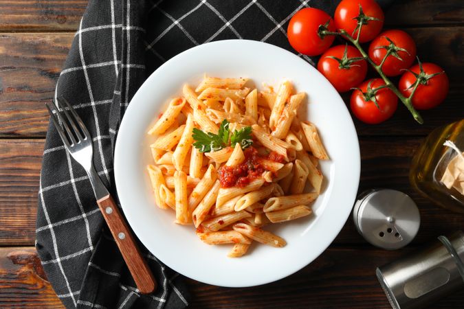 Composition with plate of tasty pasta on wooden background. Cooking pasta