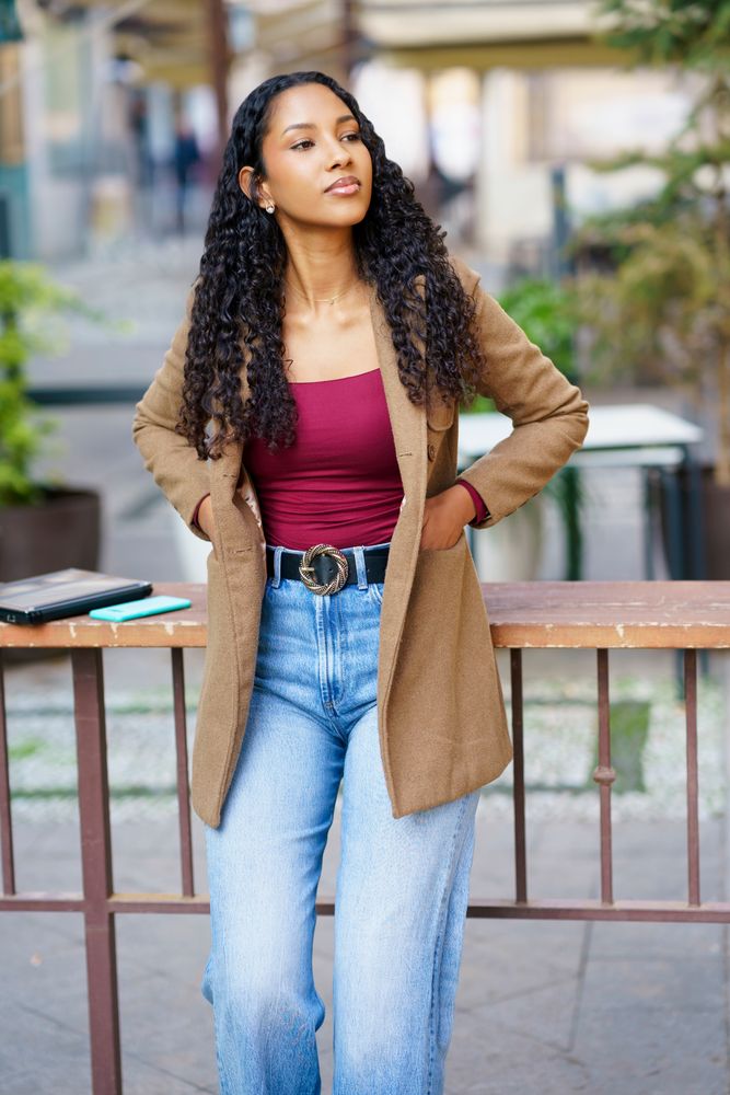 A Stylish and Young Woman is Posing Outdoors with a Trendy and Fashionable Outfit