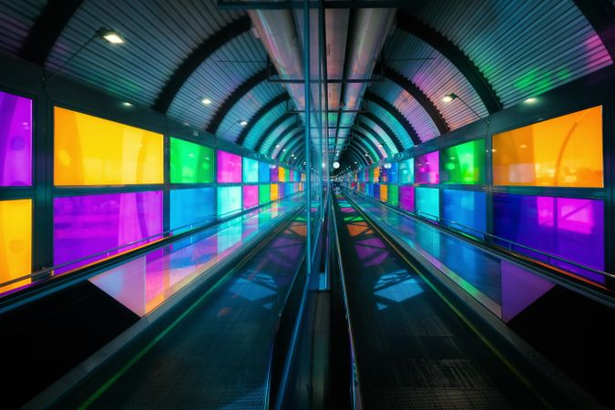 travelator in airport with colorful walls