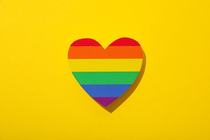 Pride parade concept, free love symbol on yellow background.