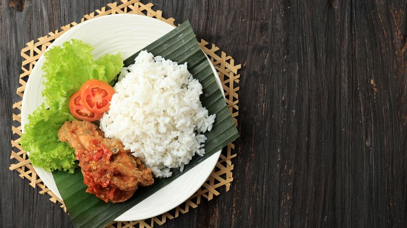 Plate of ayam penyet geprek, Indonesian spicy garlic chicken dish