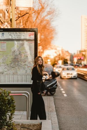 Stylish woman standing near metro station