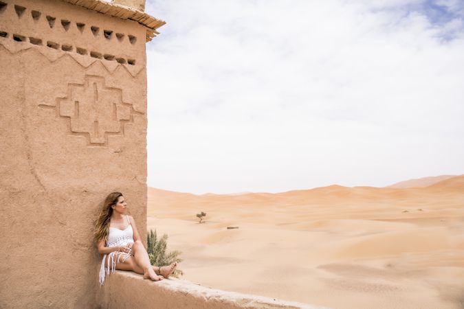 Woman on terrace against desert landscape
