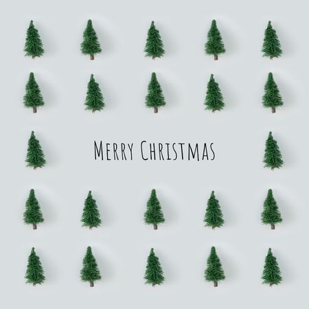 Christmas trees arranged on gray background with “Merry Christmas”