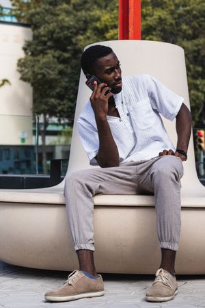 Black man talking on smartphone in city