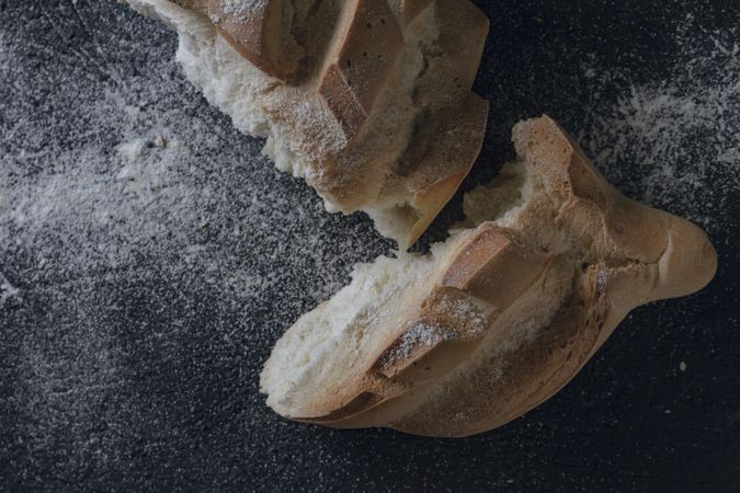 Loaf of bread with incisions on grey texture background