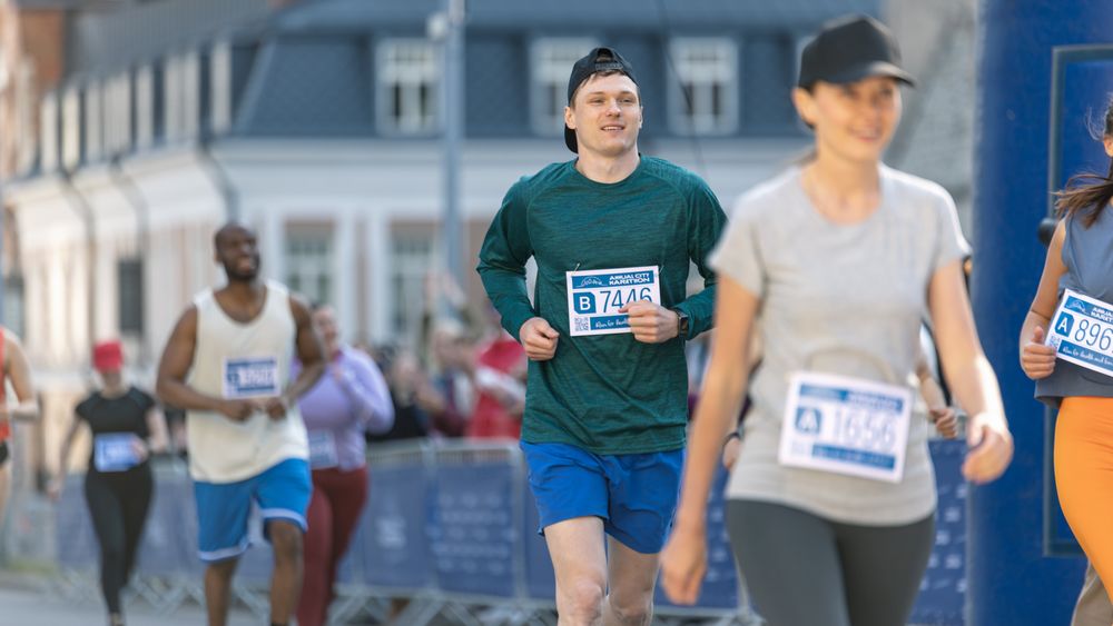 Happy Group of People Participating in a City Marathon.