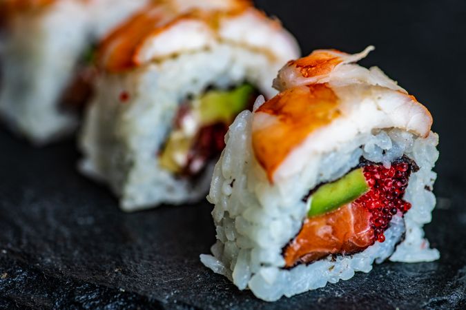 Sushi rolls with prawn, avocado and salmon