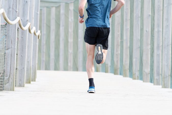 Sportsman jogging outdoors under cover