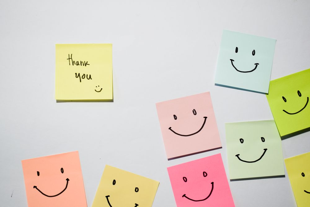 Thank you and smile emoticon on sticky notes