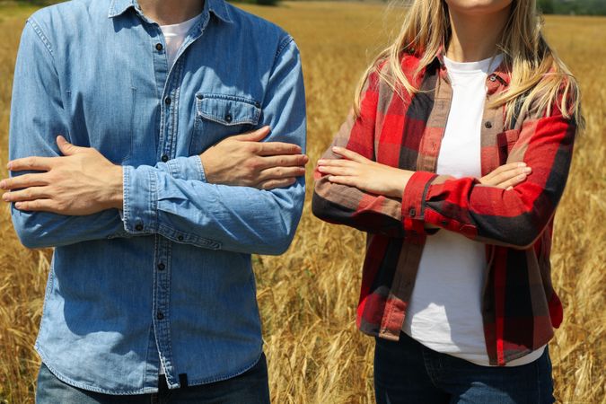Young man and woman in barley field. Agriculture business