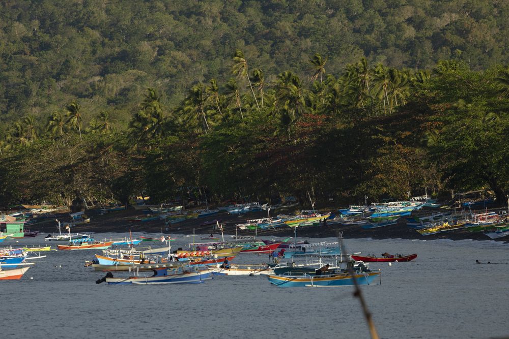 Fisherman fishing from boats near the coastline of Tangkoko Nature Reserve