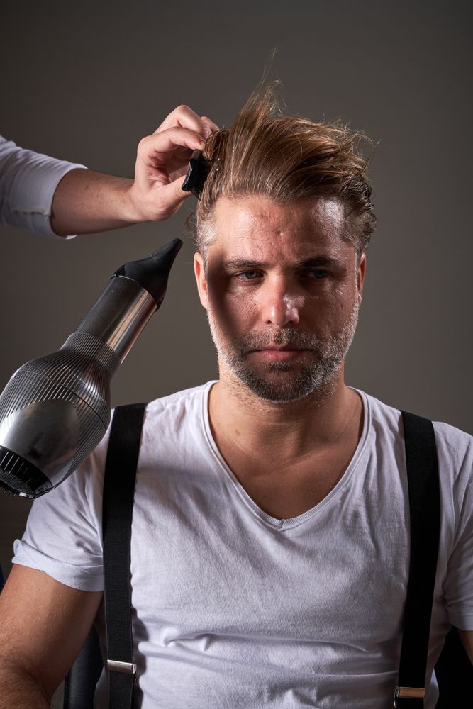 Handsome confident brutal man in barbershop