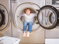 Joyful boy in washing machine
