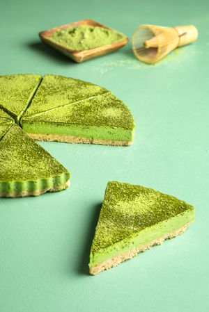 Matcha cheesecake slices on a green table