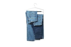 Jeans on hangers, isolated on light background