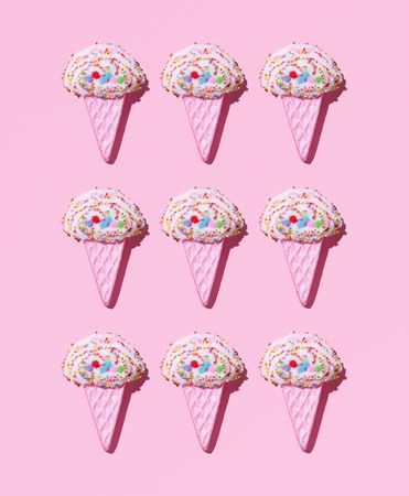 Cute ice cream cone toys on pink background