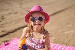 portrait of a little girl with cap and sunglasses